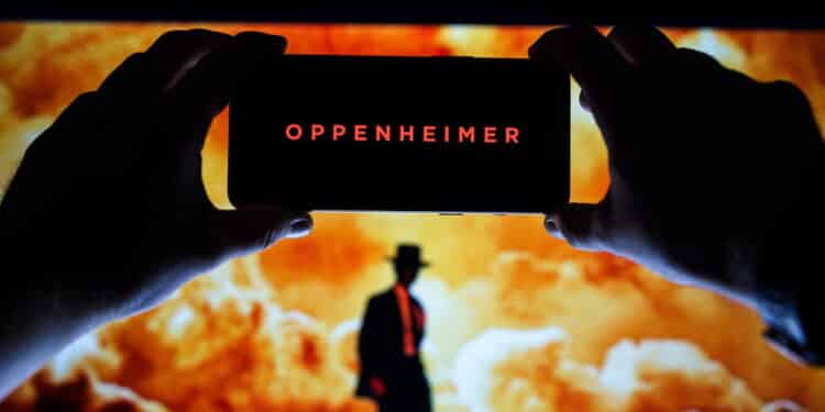 Oppenheimer movie logo and poster on screen