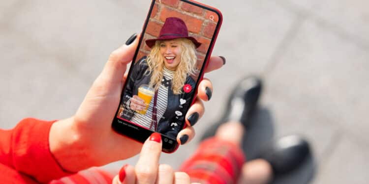 Woman viewing social media content on mobile phone