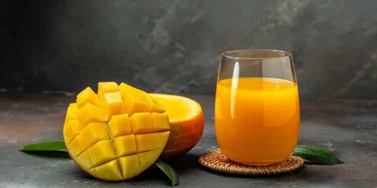 mango juice. Fresh tropical fruit smoothie on a dark background